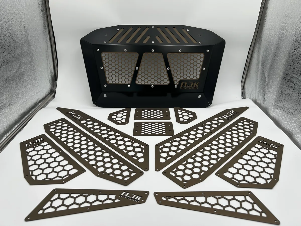 Finished automotive grille and accessory panels