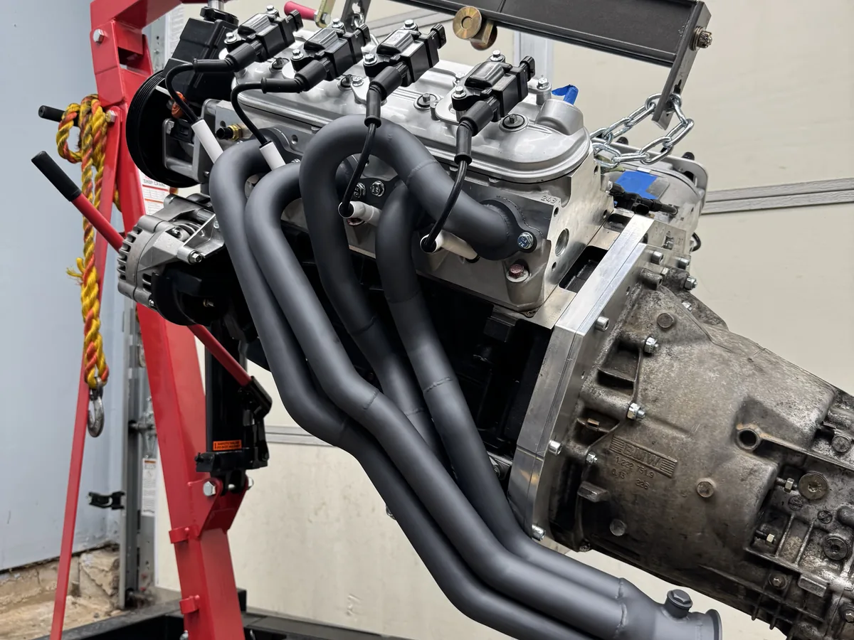 Matte dark Cerakoted exhaust headers on a motorcycle engine