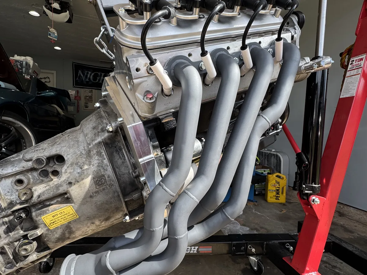 Motorcycle engine and exhaust headers before the matte dark ceramic finish