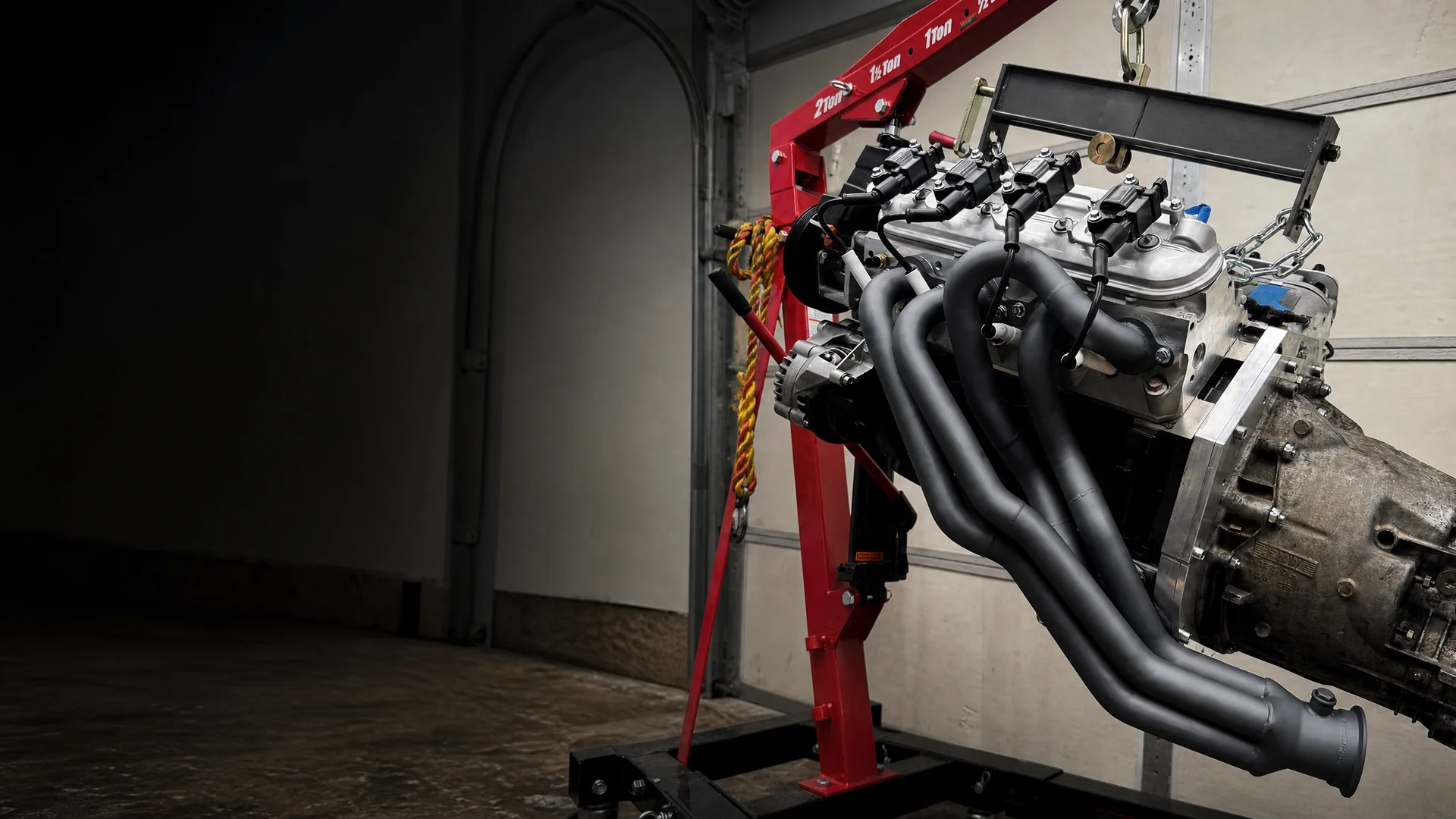 Matte dark Cerakoted motorcycle exhaust headers on an engine stand